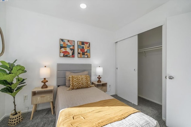 bedroom with dark carpet and a closet