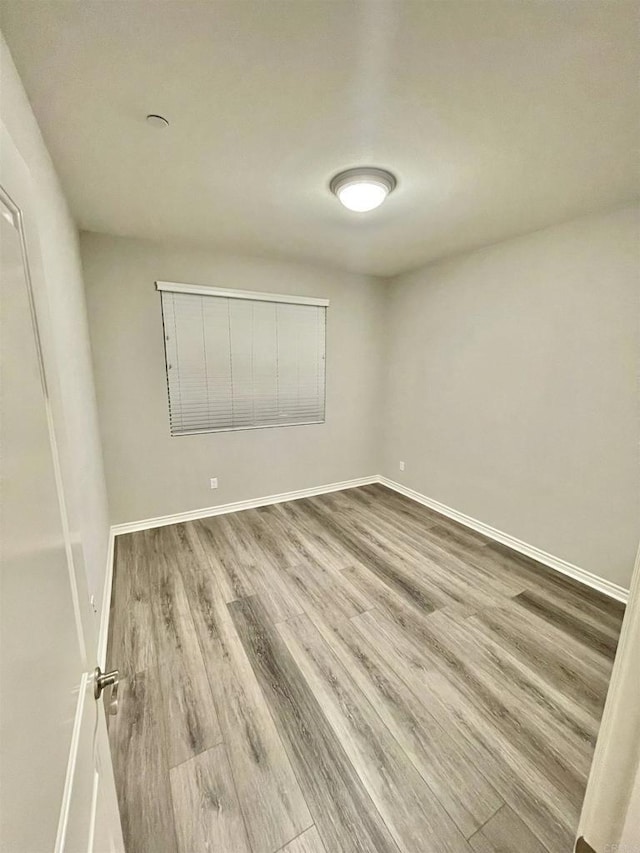 unfurnished room featuring hardwood / wood-style flooring