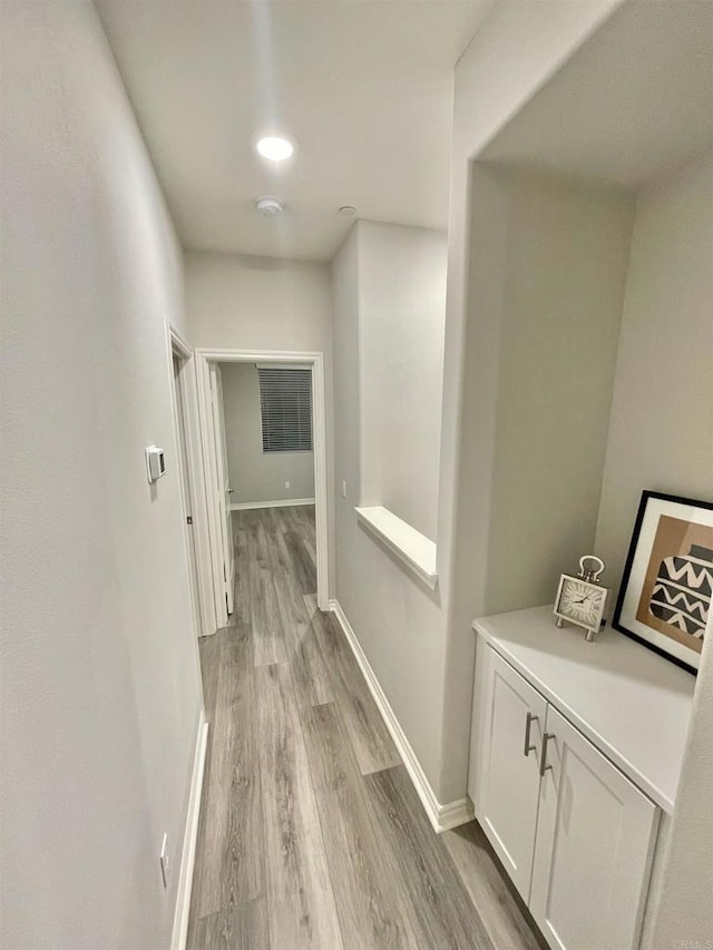 corridor with light hardwood / wood-style floors