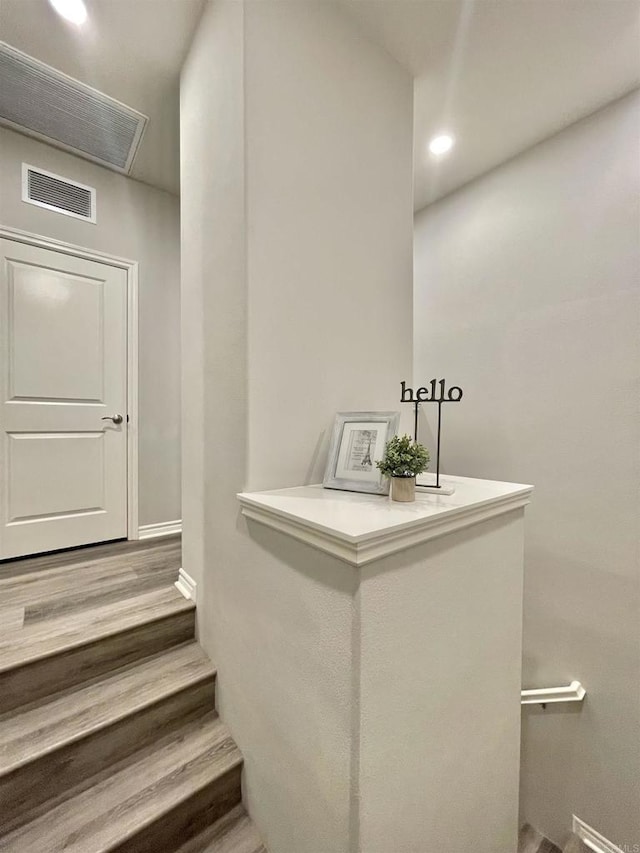 stairway featuring hardwood / wood-style flooring