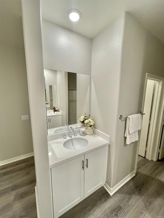 bathroom featuring hardwood / wood-style flooring and vanity