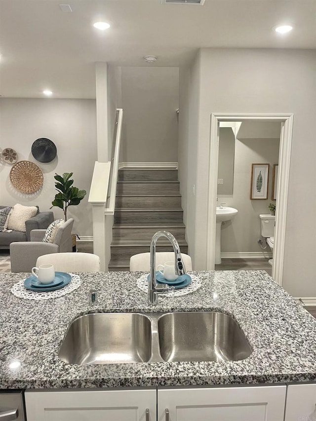 interior details featuring white cabinets and dark stone counters