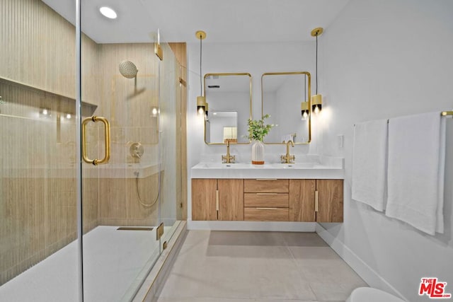 bathroom with tile patterned flooring, vanity, and walk in shower