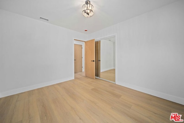 unfurnished room with light hardwood / wood-style floors