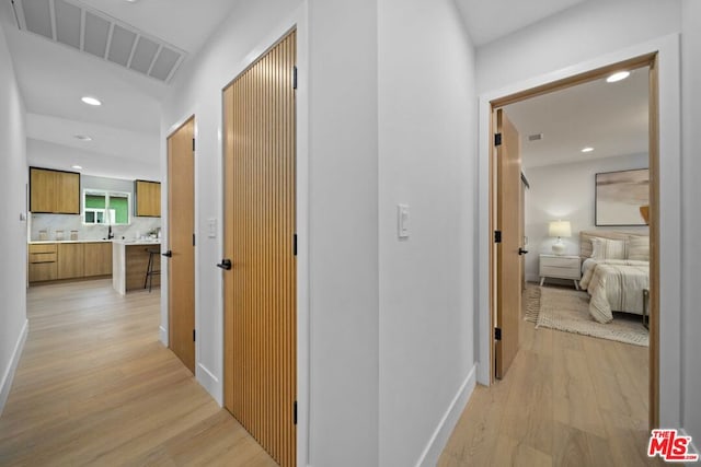 hall with light hardwood / wood-style flooring