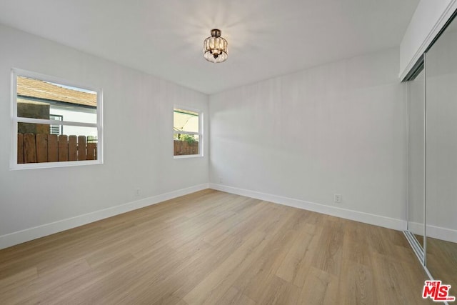 spare room with light hardwood / wood-style floors