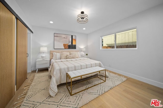 bedroom with hardwood / wood-style floors