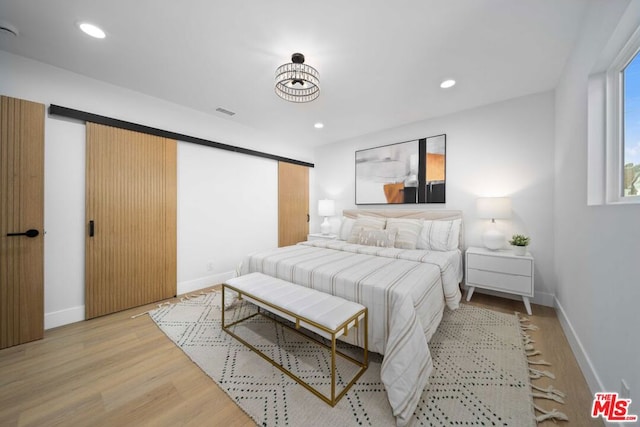 bedroom with light hardwood / wood-style floors