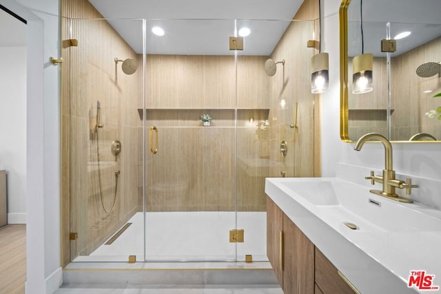 bathroom featuring an enclosed shower and vanity