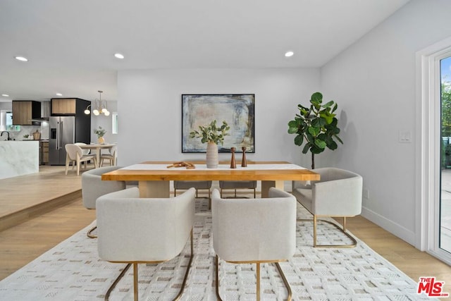 dining room featuring an inviting chandelier and light hardwood / wood-style flooring