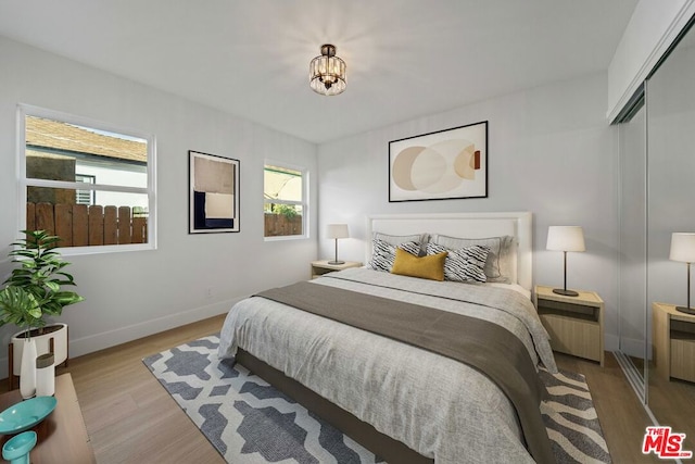 bedroom with a closet and light hardwood / wood-style flooring