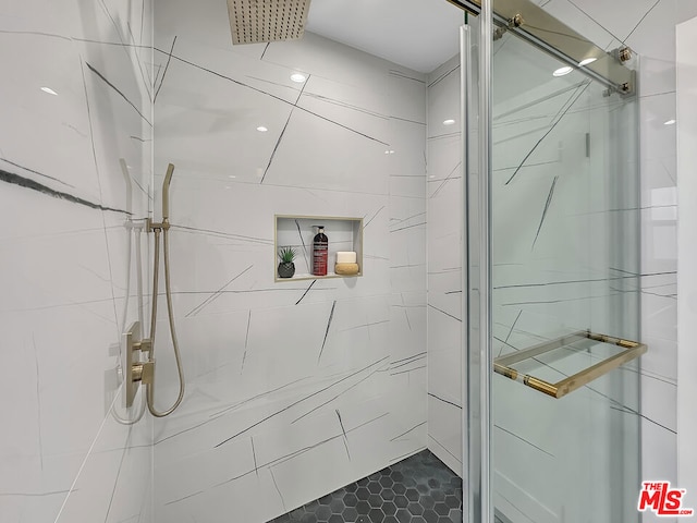 bathroom with a shower with door