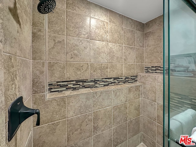 bathroom with tiled shower