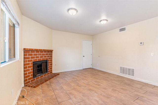 unfurnished living room featuring a brick fireplace