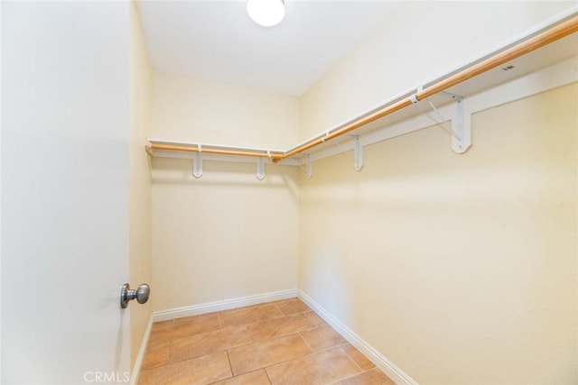 spacious closet with light tile patterned floors