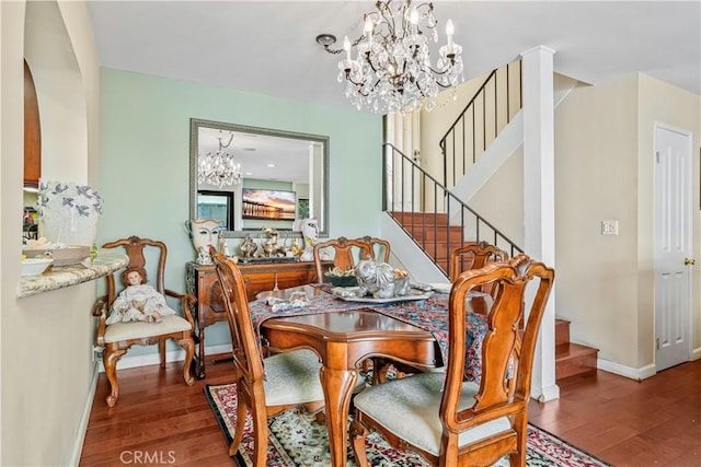 dining room with hardwood / wood-style floors and an inviting chandelier