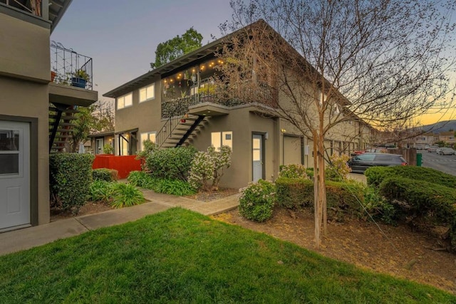 back house at dusk with a yard