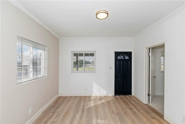 entrance foyer with crown molding and light hardwood / wood-style floors