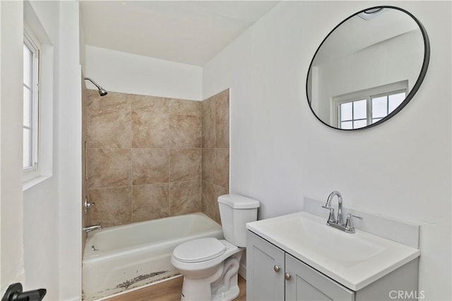 full bathroom featuring vanity, toilet, and tiled shower / bath