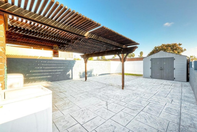 view of patio / terrace featuring a pergola, a shed, and washer / dryer