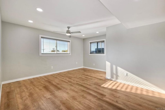 empty room featuring ceiling fan and light hardwood / wood-style floors