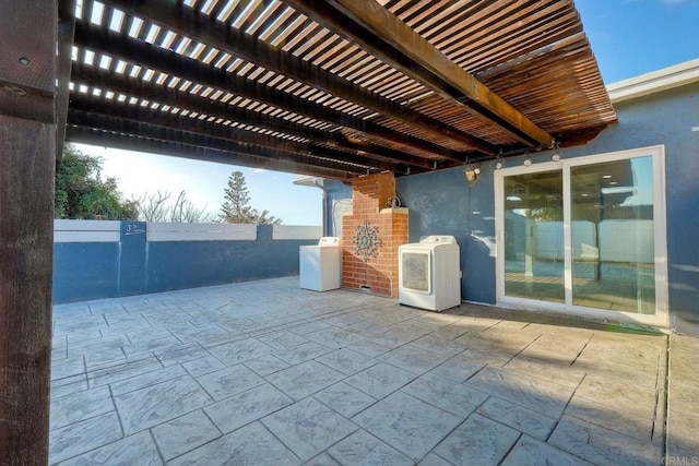 view of patio with a pergola and washer and dryer