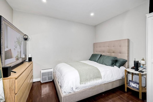 bedroom with dark hardwood / wood-style floors