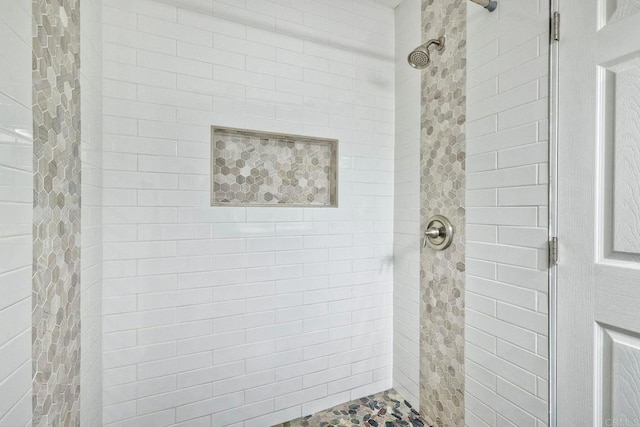 bathroom featuring a shower with door