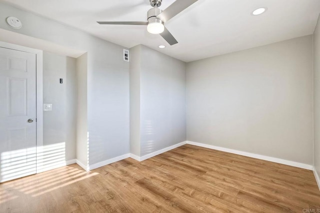 unfurnished room with ceiling fan and light wood-type flooring