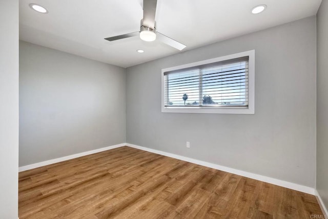 empty room with hardwood / wood-style flooring and ceiling fan