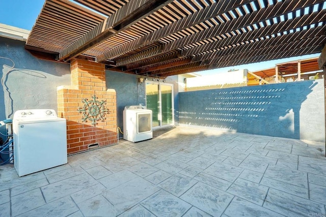 view of patio featuring washer / clothes dryer and a pergola