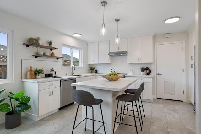 kitchen with white cabinetry, dishwasher, a kitchen island, and hanging light fixtures