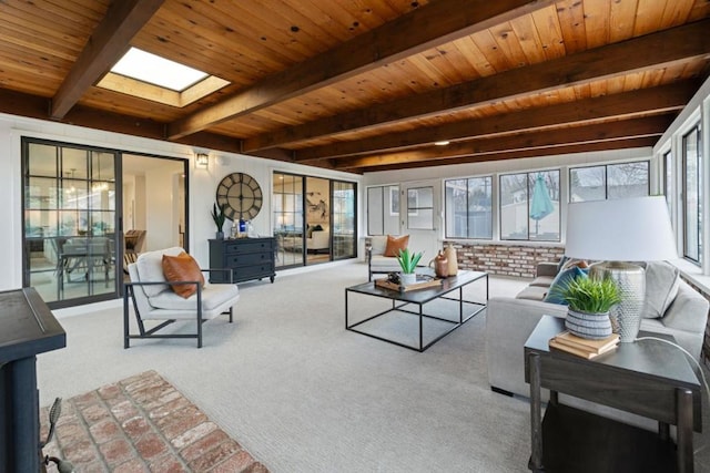 sunroom / solarium with beamed ceiling, wooden ceiling, and a skylight