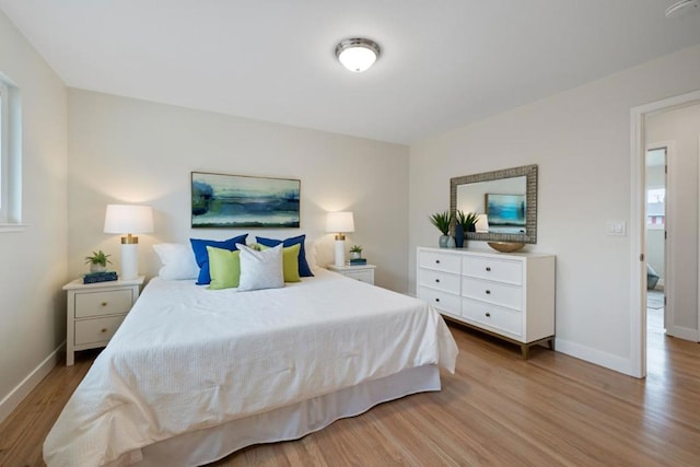 bedroom featuring light hardwood / wood-style floors and multiple windows