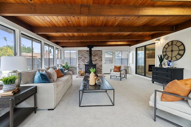 living room with a wood stove, light carpet, wooden ceiling, and beam ceiling