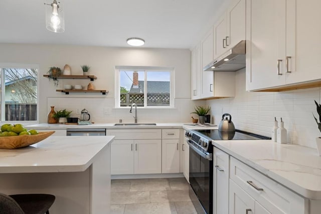 kitchen featuring white cabinetry, black range with electric stovetop, light stone counters, and sink