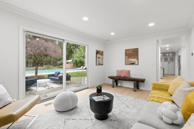 living room with ornamental molding and light wood-type flooring