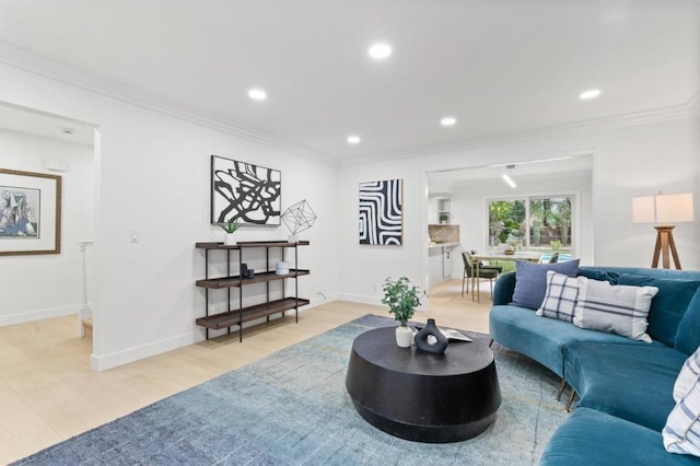 living room with crown molding and light hardwood / wood-style floors