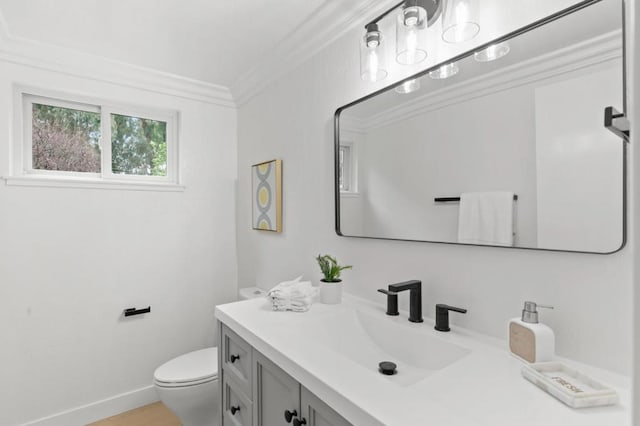 bathroom featuring vanity, ornamental molding, and toilet