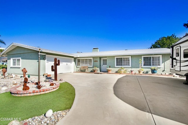 ranch-style house featuring a garage and a front yard