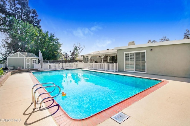 view of pool featuring a patio and an outdoor structure