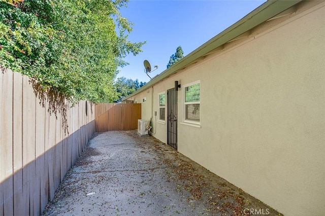 view of side of home featuring ac unit