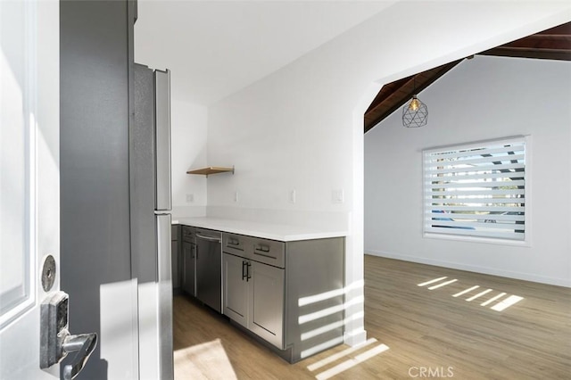 bar featuring gray cabinetry, vaulted ceiling with beams, light hardwood / wood-style flooring, and stainless steel dishwasher