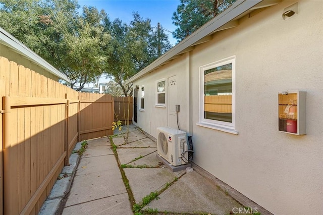 view of property exterior with ac unit and a patio area