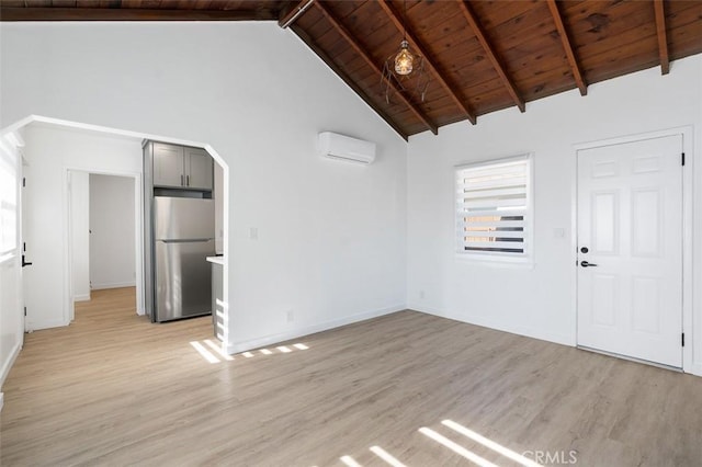 unfurnished living room with a wall mounted air conditioner, high vaulted ceiling, light hardwood / wood-style flooring, wooden ceiling, and beam ceiling