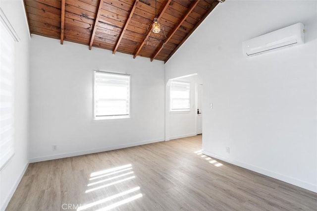 unfurnished room with wood ceiling, light hardwood / wood-style floors, an AC wall unit, and beamed ceiling