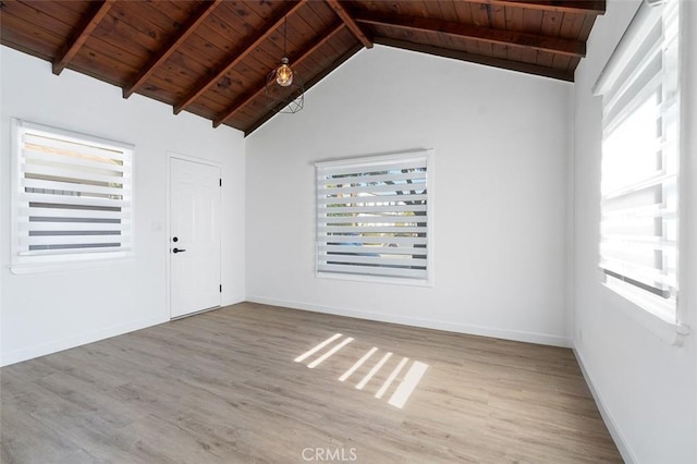 unfurnished room featuring a wealth of natural light, wooden ceiling, and light hardwood / wood-style floors