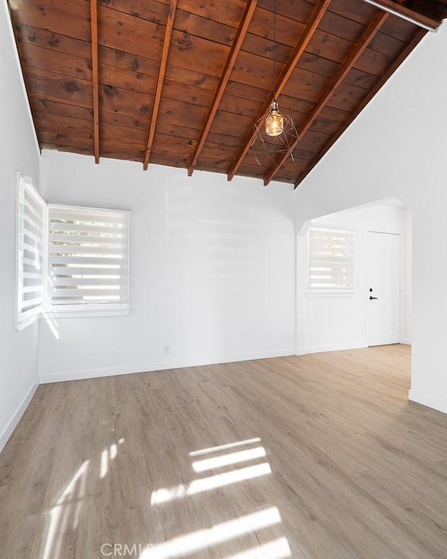 spare room with beam ceiling, wood ceiling, high vaulted ceiling, and light wood-type flooring