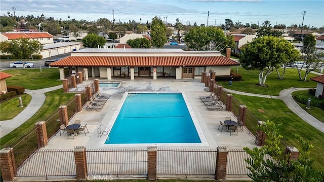 view of swimming pool featuring a patio and a lawn