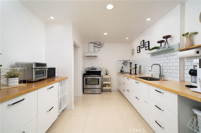 kitchen with white cabinets, sink, stainless steel range with electric cooktop, and exhaust hood